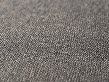 Macro close-up of premium charcoal wool fabric weave, showing precise stitching alignment and tension-free lay under soft diffused studio lighting, sharp focus, 35mm lens.