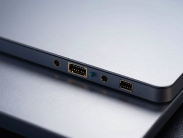 Sharp macro focus on modern silver server hardware interfaces, cool diffused studio light with deep navy reflections, minimalist tech photography