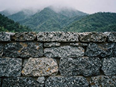Macro shot of dry-stack stone wall joints, showing precise fit of native granite, misty mountain daylight.