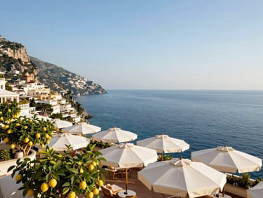 Bright daylight view of a luxury boutique hotel terrace overlooking the deep blue sea in Positano, white umbrellas, lemon trees