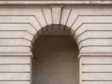 Minimalist architectural detail of a classic London stone archway, soft morning light, clean lines