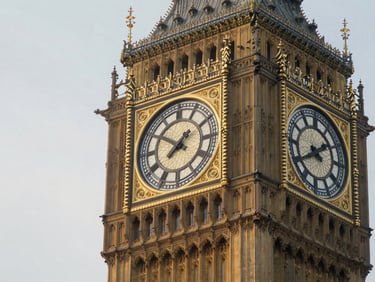 Close-up architectural detail of the Westminster Palace clock tower in London, soft morning mist, elegant slate tones
