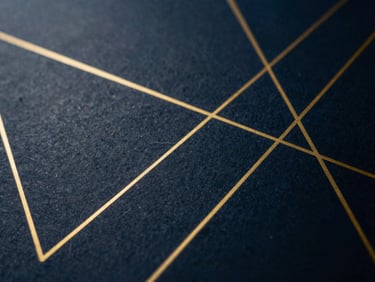 Abstract geometric pattern of gold lines on a dark blue background, representing compounding growth, high contrast.