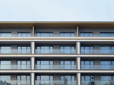 Straight-on elevation of a contemporary low-rise commercial building facade, clean structural lines, soft overcast daylight