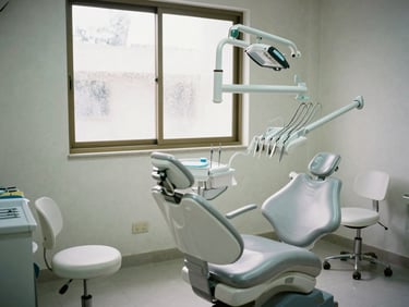 Documentary wide shot of a bright dental clinic interior in Dhaka, clean white chairs, instruments laid out, soft natural daylight through frosted window