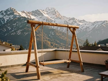 A wooden swing on a sunny rooftop terrace, dramatic snow-capped Stok mountain range in the background, warm golden sunlight, 35mm film aesthetic