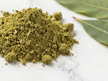 Macro close-up of vibrant green Moringa powder next to dried leaves on a white marble surface, bright daylight, 35mm