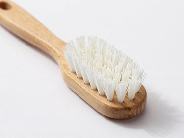Macro shot of a high-quality, unbranded scrubbing brush with a wooden handle and white bristles, clean natural daylight.