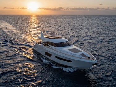 Dynamic wide-angle shot of a sleek, modern yacht sailing through deep blue water at sunrise, reflecting golden light, clean lines.
