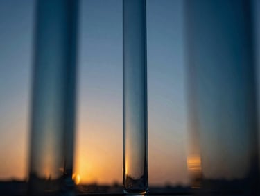 Abstract glass and light refractions, deep blue and cyan tones, creating a sense of clarity and precision, studio lighting.