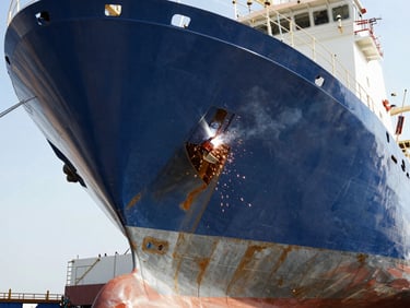 Close-up of a marine vessel hull under construction in a shipyard, steel plates, welding sparks, industrial lighting, high contrast