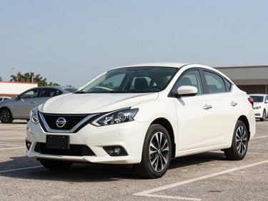Three-quarter exterior shot of a white Nissan Sentra parked on a sun-lit Cayman parking area, full vehicle profile, honest daylight showing body condition clearly
