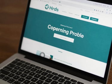 Close-up of a company profile website displayed on a laptop screen, teal brand palette, clean navigation visible, studio lighting, sharp screen clarity