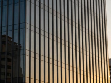 Modern architectural glass facade of a financial district building in Cairo, reflecting warm golden hour sunlight, shallow depth of field