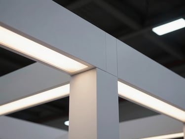 A close-up of pristine fabrication details on a custom exhibition stall, showcasing seamless joints and glowing LED panels under crisp architectural lighting