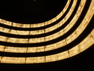 Close-up macro shot of a premium curved LED screen array glowing with vibrant gold light in a dark studio, sharp geometric patterns, architectural precision