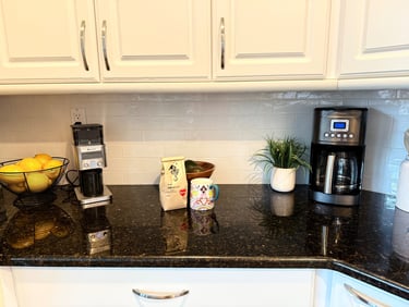 Cozy kitchen coffee station with grinder, coffee maker, coffee bag, and bright mug.