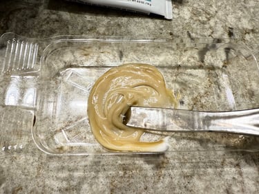 Tint mixture blended in tray, ready to apply for at home eyebrow tinting.