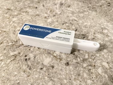 Pumice stone toilet bowl cleaner in its container on a bathroom for removing hard water stains