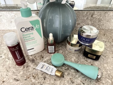 Bathroom counter with skincare products, vase, and flowers, representing a peaceful skincare routine