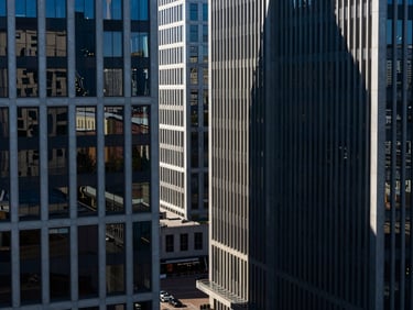 High-angle architectural view of modern corporate office buildings in St. Petersburg, sharp shadows, cool high-contrast daylight, deep blue tones