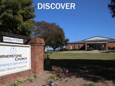 Front of church building with sign.