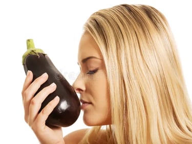 blonde, white woman smelling an eggplant