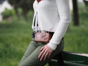 a woman with miniature wooden bag with tooth motif