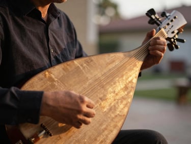 Close-up portrait of a kora player's hands on strings, golden afternoon light raking across the instrument's gourd body, blurred outdoor courtyard behind