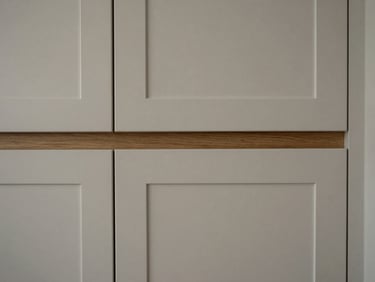 Close-up of kitchen cabinetry with engineered quartz cladding and integrated wood accents, soft diffused side-light, sharp focus, 35mm lens, architectural interior photography