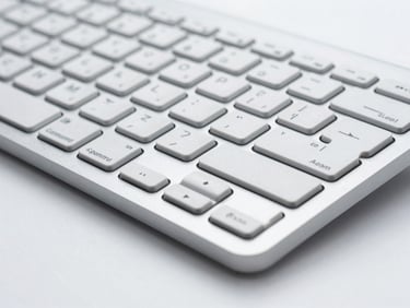 Close-up of a sleek, ergonomic enterprise-grade keyboard on a clean white surface, cool lighting.