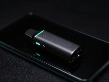 Sleek black disposable vape device resting on obsidian glass, glowing mint-green ambient light, moody low-key studio lighting