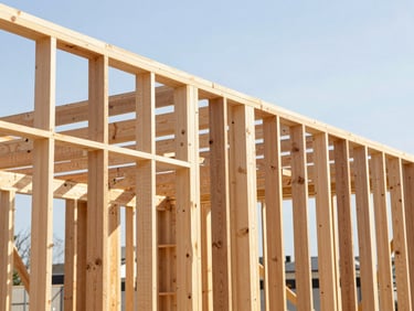 Close-up of precise wooden structural framing in a high-end residential construction, bright daylight, clean lines.