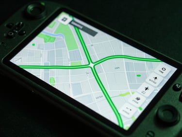 Macro shot of a rugged Android handheld device displaying a high-contrast map interface with fluid green route overlays, low-key lighting