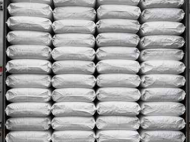 Close-up of industrial packaging labels on sacks, showing export-grade details, bright high-key studio lighting, sharp focus, minimalist composition, 35mm