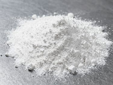 Fine white TGIC powder on a dark industrial surface, sharp focus, bright overhead lighting, technical and precise, 35mm