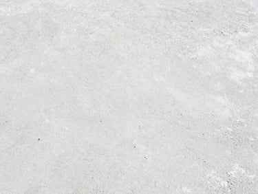 Close-up of a concrete surface treated with a construction chemical, showing enhanced durability and water resistance. Crisp natural daylight, sharp focus on the treated texture, minimalist composition, 35mm.
