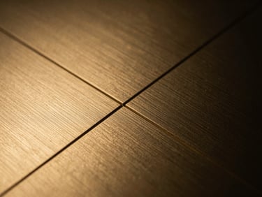 Tight macro crop of brushed gold metal texture with ultra-thin geometric lines, dark low-key lighting