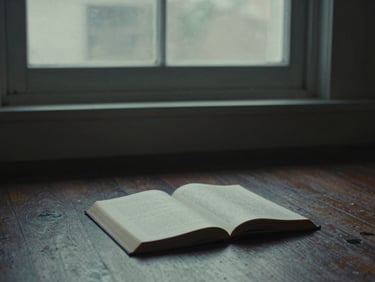 Cinematic 16:9 still of a dark room with light streaming through a dusty window, a single open book on the floor, 35mm film grain, muted cool tones