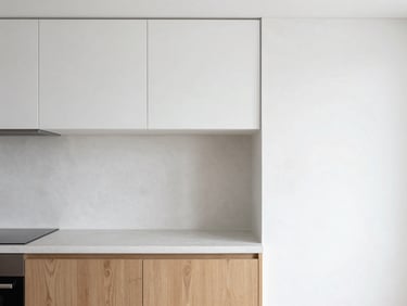 Architectural interior photography, bright natural daylight, clean white plaster textures, a minimalist kitchen with oak wood meeting microcement, sharp details, 35mm