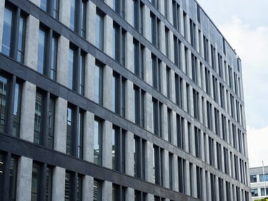 Architectural lines of a modern, clean corporate office building, bright natural daylight, cool tones, sharp focus, 35mm