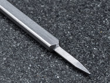 Close-up of raw forged steel tool on a dark granite surface, high-contrast natural light, sharp textures, 35mm