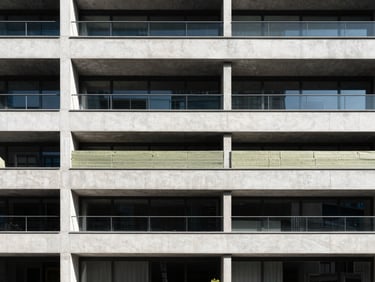 Architectural detail of a building facade showing thermal insulation layers or a high-performance window frame, sharp natural daylight, deep shadows, minimalist, wide-angle lens, 35mm