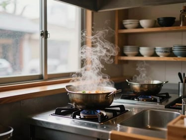 Wide shot of a small ramen counter kitchen at pre-opening — a steaming pot on a gas burner, north-facing window light illuminating the steam, wooden shelving with ceramic bowls in the background, no people present