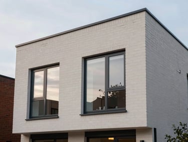 Architectural elevation of a modern house extension in Manchester, clean brickwork integration, dusk lighting, 35mm photography
