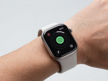 Close-up of a modern smartwatch on a wrist, displaying a health metric, diffused studio lighting, light gray background, sharp details, high-contrast, 85mm lens