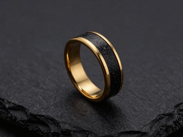 Tight macro shot of a gold ring with a raw black slate inlay, textured surface, emerging from deep shadows, dramatic low-key lighting.