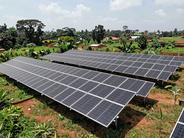Wide environmental engineering shot of a ground-mounted solar microgrid in Rwanda, surrounded by lush terrain, bright high-contrast daylight, sharp architectural shadows.