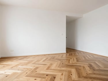 Crisp architectural photography of a modern interior renovation, bright natural daylight, clean white walls, newly laid oak parquet flooring, sharp focus, 35mm lens