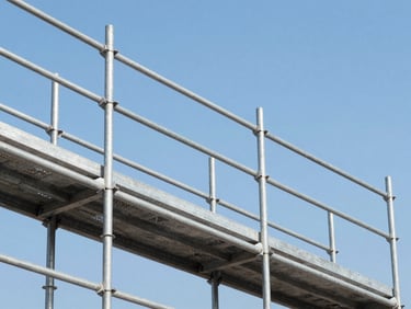 Close-up detail shot of a construction site with clean metal scaffolding against a bright blue sky, cool industrial colors, sharp focus, 35mm lens